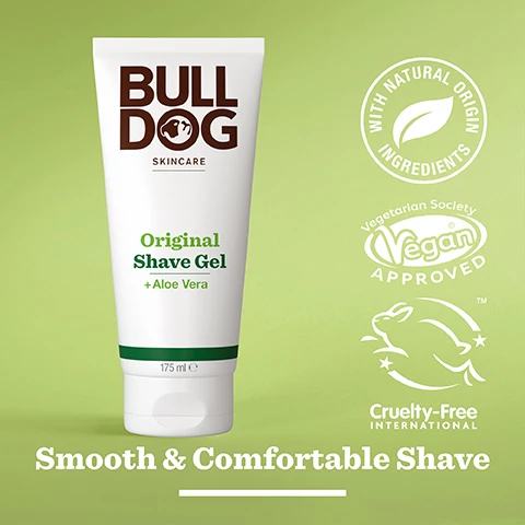 Image 2 - A white tube of Bulldog Skincare Original Shave Gel with green accents, featuring text that reads Original Shave Gel + Aloe Vera, nestled on a light green background, with logos indicating it is vegan approved, cruelty-free, and made with natural origin ingredients, along with the phrase Smooth & Comfortable Shave.
Image 3 - A close-up image of a green aloe vera leaf with a glistening droplet of water, featuring text that reads 95% Natural Origin, Unlock the true potential of natural origin ingredients, Aloe Vera.
Image 4 - A person holds a tube of Bulldog Skincare Original Shave Gel in front of a bathroom background, with visible text stating Normal To Dry Skin.
Image 5 - A tube of Bulldog Original Shave Gel with aloe vera, featuring the text indicating it is made of more than 27% sugarcane and over 62% PCR plastic, sits on a marble surface with a plant in the background and the words Recycled Tube below.