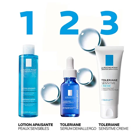 Image 2 - Three La Roche-Posay skincare products, a blue lotion bottle, a blue serum dropper bottle, and a white cream tube, are arranged left to right with clear water droplets on a white background, with visible text reading 1, 2, 3, LOTION APAISANTE PEAUX SENSIBLES, TOLERIANE SERUM DEMALLERGO, TOLERIANE SENSITIVE CREME. Image 3 - A blue bottle of La Roche-Posay Soothing Lotion with a white cap is displayed against a background featuring vertical stripes of various skin tones from light to dark, with prominent text Soothing Lotion and Suitable For All Skin Types, and text on the bottle reading La Roche-Posay Laboratoire Dermatologique, Lotion Apaisante Peaux Sensibles, Soothing Lotion Sensitive Skin, Soothes, tones and protects Physiological pH, 200 ml - 6.76 FL.OZ. Made in France. Image 4 - A tall, transparent blue bottle of La Roche-Posay Soothing Lotion for sensitive skin with a white cap is displayed on a white background, next to two steps for application: LA ROCHE-POSAY LABORATOIRE DERMATOLOGIQUE LOTION APAISANTE PEAUX SENSIBLES AVEC DE LEAU THERMALE DE LA ROCHE-POSAY Apaise, tonifie et protège pH physiologique VISAGE ET YEUX SENSIBLES SENSITIVE FACE AND EYES SOOTHING LOTION SENSITIVE SKIN WITH LA ROCHE-POSAY THERMAL SPRING WATER Soothes, tones and protects Physiological pH 200 ml - 6.76 FL.OZ. Made in France 1 APPLY TO A COTTON PAD 2 GENTLY APPLY TO FACE.