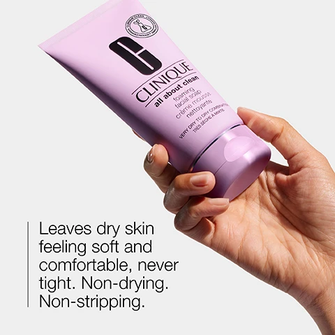 Image 1 - A person is holding a tube of Clinique All About Clean Foaming Facial Soap, which is purple with a prominent black letter G and the Clinique logo, alongside text that reads Leaves dry skin feeling soft and comfortable, never tight. Non-drying. Non-stripping.
Image 2 - The image shows two transparent dishes, one containing a clear gel labeled Hyaluronic acid and the other a thicker, creamy substance labeled Glycerin.