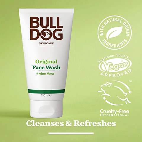 Image 2 - A tube of Bulldog Original Face Wash with aloe vera, featuring a green label and various certification logos indicating vegan and cruelty-free status, against a light green background, with the text Cleanses & Refreshes.
Image 3 - A close-up of a green aloe vera leaf with a glistening gel surface, featuring the text 94% Natural Origin, Unlock the true potential of natural origin ingredients, and Aloe Vera.
Image 4 - A hand pours a clear facial wash labeled Original Face Wash + Aloe Vera into another hand, with text below reading Normal To Dry Skin.
Image 5 - A person is holding a white tube of Bulldog Skincare Original Face Wash, which features green text on the front and rests on a marble countertop next to a green towel, with visible text indicating that the tube is made from recycled materials.