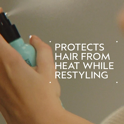 Image 2 - A persons hand holds a light blue spray bottle, releasing a fine mist, with the text PROTECTS HAIR FROM HEAT WHILE RESTYLING. Image 3 - A before and after comparison shows a young woman with long blonde hair; the left panel, labeled BEFORE, depicts her with straight, unwashed-looking hair and a neutral expression, while the right panel, labeled AFTER, shows her with styled, voluminous wavy hair and a smile. Additional text on the bottom left reads Unwashed Hair, and on the bottom right reads Results with Heat Relief™ Thermal Protector & Conditioner Mist, Shampowder™ Dry Shampoo, and Mini Wooden Paddle Brush. Styled with curling iron. Image 4 - The image displays a dark green background with a light blue-green circular area, upon which are arranged lavender sprigs, white blossoms, and yellow-green ylang-ylang flowers, accompanied by the text Power Your Peace and A calming aroma with a blend of 25 pure flower and plant essences including lavender, petitgrain, and ylang ylang. Image 5 - The image illustrates three steps for hair care, featuring a woman spraying a bottle towards her hair, another woman spraying dry shampoo into her hair, and powder being dispensed onto a wooden paddle brush, with the text How To Use, 01 MIST Heat Relief™ Thermal Protector & Conditioner Mist, 02 DRY SHAMPOO Shampowder™ Dry Shampoo, and 03 BRUSH Mini Wooden Paddle Brush. Image 6 - A dollop of white liquid, possibly lotion or paint, is shown on a white background. Image 7 - Three white certification logos are displayed over dark green leaves: a V inside a circle with the text 100% VEGAN, a Certified B Corporation logo, and the Leaping Bunny logo with the text Cruelty Free INTERNATIONAL.