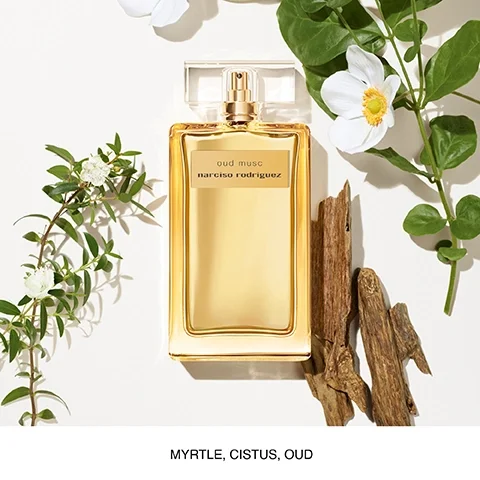 A golden perfume bottle labeled oud musc narciso rodriguez is surrounded by greenery and wood pieces, with the text MYRTLE, CISTUS, OUD displayed below.