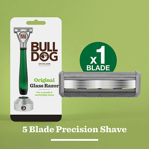 Image 2 - Image of a Bulldog Skincare packaging featuring an original glass razor with a green handle and a silver base, accompanied by a gray replacement blade and text stating 5 Blade Precision Shave and x1 BLADE.
Image 3 - An overhead view of a silver razor with multiple blades and a textured grip, accompanied by the text A smooth comfortable shave.
Image 4 - A close-up of a person shaving their beard with a razor featuring a metallic head and a green handle, with shaving cream applied to the skin and text that reads responsibly crafted handle made using recycled glass.
Image 5 - A close-up of a silver and green razor with the brand name BULLDOG on its handle, accompanied by the text A quality shave responsibly crafted in a stylized font.