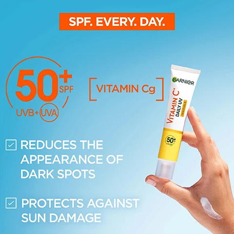 Image 1 - An advertisement for Garnier Vitamin C Daily UV cream featuring a hand holding the tube against a blue background, with visible text indicating SPF 50+, benefits of reducing dark spots, and sun damage protection.
Image 2 - Image of a Garnier sunscreen tube labeled Vitamin C Daily UV Invisible with a yellow background, highlighting very high protection against UVA, UVB, and long UVA, featuring checkmarks for non-greasy, non-oily, non-comedogenic, and lightweight & invisible formula, as well as no residues and no white cast.
Image 3 - A hand is holding a tube of Garnier Vitamin C cream, while another hand is receiving a small amount of the cream, with the background showing a gradient of blue; visible text includes HOW TO APPLY? and TWO FINGER RULE FOR WHOLE FACE & NECK.
Image 4 - Image shows two tubes of Garnier Vitamin C Daily UV sunscreen on a bright yellow background, one labeled Glow with a peach-colored cream and the other labeled Invisible with a white cream, each accompanied by arrows pointing to text descriptions, including Mineral pigments, suitable for all skin tones and Invisible & lightweight formula, no white cast.