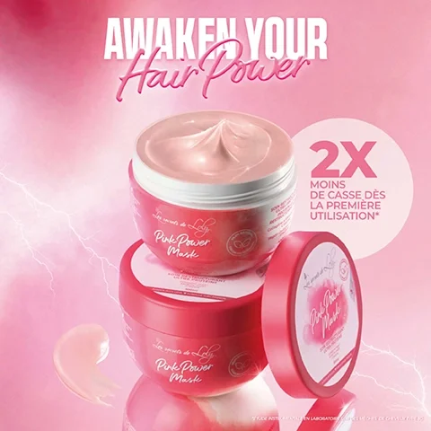 A beauty product advertisement featuring a close-up of two jars of Pink Power Mask stacked on top of each other with a creamy mask texture visible in the top jar; the text reads AWAKEN YOUR Hair Power and 2X MOINS DE CASS DE LA PREMIÈRE UTILISATION*.