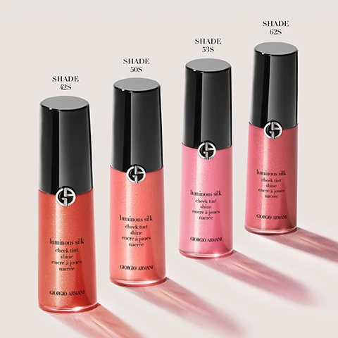 Image 1 - Four bottles of Giorgio Armani Luminous Silk Cheek Tint are displayed in shades 42S, 50S, 53S, and 62S, with corresponding labels above each bottle.
Image 2 - A close-up of a woman with fair skin and blonde hair holding a tube of liquid blush near her face, showcasing a natural makeup look, with text reading UP TO 12H SKIN-FUSING PEARLY LIQUID BLUSH and a note about a consumer test of 84 women.
Image 3 - Three close-up portraits of a woman showcasing different makeup looks with labels above each photo: Lifted Cheek Effect, Boyfriend Blush, and Monochromatic Look, along with application instructions below each image stating: Apply two dots on high cheekbones, blend towards temples, Dab blush on apples of cheeks, blend slightly outwards, stay low, Apply two dots on cheeks, one on brow bone and a touch more to lips. Blend with brush.
Image 4 - Three Giorgio Armani makeup products are displayed: a bottle labeled FOUNDATION with text stating Perfect, glowy skin in a bottle, a bottle labeled CONCEALER with text stating Lightweight, buildable formula, and a bottle labeled CHEEK TINT SHINE with text stating Longwear pearly liquid, effortless blend.