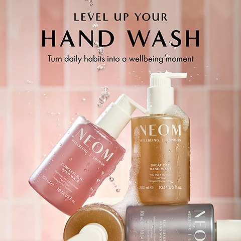 Image 1 - Three bottles of NEOM hand wash in shades of pink, gold, and gray are shown against a pink tiled background with water droplets, featuring the text LEVEL UP YOUR HAND WASH Turn daily habits into a wellbeing moment.
Image 2 - A pink bottle of NEOM Complete Bliss Hand Wash is displayed with a pump top and a few drops of liquid coming from the spout, accompanied by text describing its ingredients and benefits including blush rose, lime, black pepper, pomegranate, chamomile extracts, and aloe vera.
Image 3 - Two bottles of NEOM wellbeing products: a pink hand wash bottle on the left labeled COMPLETE BLISS HAND WASH and a white hand lotion bottle on the right, both on a light pink background with text stating 100% recyclable bottle designed to be refilled and reused and 100% natural fragrances that turn everyday moments into a wellbeing experience.
Image 4 - A hand is shown with a liquid being dispensed from a NEOM Wellbeing London bottle, with text stating 89% said it helps them to enjoy a moment of calm, followed by a note about an independent study.
