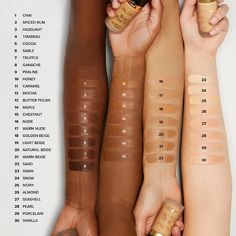 Image 1 - Foundation swatches from dark to light skin tones are displayed on four arms with numbers 1 through 30 corresponding to the visible list of shades 1 CHAI 2 SPICED RUM 3 HAZELNUT 4 TIRAMISU 5 COCOA 6 SABLE 7 TRUFFLE 8 GANACHE 9 PRALINE 10 HONEY 11 CARAMEL 12 MOCHA 13 BUTTER PECAN 14 MAPLE 15 CHESTNUT 16 NUDE 17 WARM NUDE 18 GOLDEN BEIGE 19 LIGHT BEIGE 20 NATURAL BEIGE 21 WARM BEIGE 22 SAND 23 SWAN 24 SNOW 25 IVORY 26 ALMOND 27 SEASHELL 28 PEARL 29 PORCELAIN 30 VANILLA and bottles showing Too Faced Born This Way. Image 2 - Six women display foundation shades with swatches and labels including MEDIUM-TAN NATURAL BEIGE LIGHT MEDIUM WITH NEUTRAL UNDERTONES WARM BEIGE MEDIUM WITH NEUTRAL UNDERTONES SAND MEDIUM WITH GOLDEN UNDERTONES PRALINE MEDIUM TAN WITH GOLDEN UNDERTONES HONEY TAN WITH NEUTRAL UNDERTONES CARAMEL RICH TAN WITH NEUTRAL UNDERTONES. Image 3 - A grid of six faces showing fair to light foundation shades, each with a swatch below labeled with the shade name and undertone description FAIR-LIGHT PORCELAIN FAIR WITH NEUTRAL UNDERTONES VANILLA VERY LIGHT WITH NEUTRAL UNDERTONES NUDE VERY LIGHT WITH ROSY UNDERTONES WARM NUDE VERY LIGHT WITH NEUTRAL UNDERTONES GOLDEN BEIGE LIGHT WITH GOLDEN UNDERTONES LIGHT BEIGE LIGHT WITH NEUTRAL UNDERTONES. Image 4 - Six models are shown demonstrating different makeup shades and undertones with text labels including TAN-DEEP MOCHA RICH TAN WITH ROSY UNDERTONES BUTTER PECAN RICHEST TAN WITH GOLDEN UNDERTONES MAPLE DEEP WITH NEUTRAL UNDERTONES CHESTNUT DEEP WITH NEUTRAL TO GOLDEN UNDERTONES CHAI DEEP WITH GOLDEN UNDERTONES SPICED RUM VERY DEEP WITH ROSY UNDERTONES. Image 5 - Image displays six models showcasing Deep-Rich foundation shades with text overlays and swatches below their portraits, reading DEEP-RICH HAZELNUT DEEPEST WITH ROSY UNDERTONES TIRAMISU DEEPEST WITH GOLDEN UNDERTONES COCOA DEEPEST WITH NEUTRAL UNDERTONES SABLE RICH WITH ROSY UNDERTONES TRUFFLE RICH WITH GOLDEN UNDERTONES GANACHE RICHEST WITH NEUTRAL UNDERTONES. Image 6 - Six women model foundation shades displayed as FAIR: Swan very fair with neutral undertones, Snow very fair with neutral to rosy undertones, Ivory very fair with golden undertones, Almond fair with golden undertones, Seashell fair with rosy undertones, and Pearl fair with neutral to rosy undertones. Image 7 - Split image showing a womans face before and after makeup application, with text reading BEFORE, AFTER, and MODEL IS WEARING SHADE PRALINE.