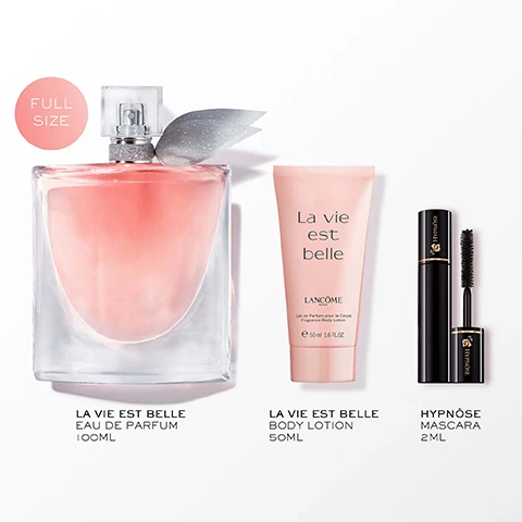 Image 2 - A Lancôme La Vie Est Belle perfume bottle with a silver ribbon and a pink circle reading FULL SIZE, alongside a Lancôme La Vie Est Belle Fragrance Body Lotion tube, and a Lancôme Hypnôse mascara with its wand extended, with text below them reading LA VIE EST BELLE EAU DE PARFUM 100ML, LA VIE EST BELLE BODY LOTION 50ML, and HYPNÔSE MASCARA 2ML. Image 3 - A clear perfume bottle with pink liquid is centered against a background of white flower petals, green leaves, and vanilla bean pods, with text labels Iris, Warm Vanilla, Spun Sugar, Earthy Patchouli. Image 4 - A light pink Lancôme perfume bottle with a clear crystal cap and silver ribbon rests on a decorative pink box adorned with gold and silver illustrations of a clock face with Roman numerals, a train, the Eiffel Tower, and snowflakes, with visible text reading Lancôme Paris, Since 1935, extraordinary, LANCOME-Express, and Our First Tasty Iris Fragrance. Image 5 - A promotional image displays three Lancôme perfume bottles and pink gift boxes featuring a Parisian clock face design, set against pink curtains and a mountain view from a window, with text that reads: SHOP THE COLLECTION, NEW VANILLE NUDE, LORIGINAL EAU DE PARFUM, LELIXIR EAU DE PARFUM, LANCOME PARIS, LANCÔME, and gift the extraordinary.