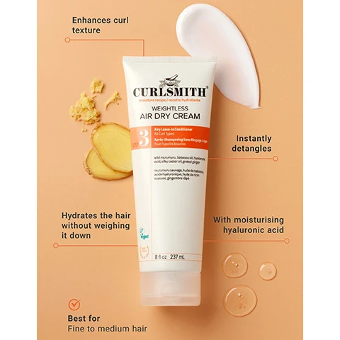 Image 1 - A Curlsmith Weightless Air Dry Cream tube stands on a peach background with ginger slices, a cream blob, and liquid drops, surrounded by text that reads: Enhances curl texture, Instantly detangles, Hydrates the hair without weighing it down, With moisturising hyaluronic acid, Best for Fine to medium hair, and product labels CURLSMITH moisture recipe / recette hydratante WEIGHTLESS AIR DRY CREAM Airy Leave-In Conditioner All Curl Types Après-Shampooing Sans Rinçage Léger Tous Type De Boucles, a number 3, ingredients including wild murumuru, babassu oil, hyaluronic acid, silky castor oil, grated ginger in English and French, a Vegan logo, and 8 fl oz 237 mL. Image 2 - A hand holds a white tube of Curlsmith Weightless Air Dry Cream against an orange background, with the text HYDRATION WITHOUT THE WEIGHT and on the tube CURLSMITH MOISTURE RECIPE / RECETTE HYDRATANTE WEIGHTLESS AIR DRY CREAM 3 Airy Leave-In Conditioner All Curl Types Après-Shampooing Sans Rinçage Léger Tous Types De Boucles wild murumuru, babassu oil, hyaluronic acid, alkyldetox, grand ginger murumuru sauvage, huile de babassu, acide hyaluronique, huile de riz, ankylose, gingembre râpé 8 fl oz 237 mL. Image 3 - A smiling woman with abundant light brown and blonde curly hair is featured against a peach background, with the text: MOST LOVED MOST TRUSTED The go-to formula for defined moisturized curls. Image 4 - A white tube of Curlsmith Weightless Air Dry Cream is shown against an orange background with the text Hydration without the weight, Curlsmith, moisture recipe / recette hydratante, Weightless Air Dry Cream, 3 Step, Airy Leave-in Conditioner, All Curl Types, Après-Shampooing Sans Rinçage Léger, Tout Type De Boucles, wild murumuru, babassu oil, hyaluronic acid, silky castor oil, grated ginger, murumuru sauvage, huile de babassu, acide hyaluronique, huile de ricin soyeuse, gingembre râpé. Image 5 - Two tubes of Curlsmith Weightless Air Dry Cream are shown side-by-side on a split blue and orange background, indicating a packaging change from left to right, with the left tube displaying CURLSMITH SCALP RECIPE WEIGHTLESS AIR DRY CREAM Airy Leave-in Conditioner All Curl Types 8 fl oz / 237 mL, and the right tube featuring an orange circle with SAME GREAT NEW LOOK PRODUCT, alongside CURLSMITH MOISTURE RECIPE WEIGHTLESS AIR DRY CREAM 3 STEP Airy Leave-in Conditioner All Curl Types 8 fl oz / 237 mL.